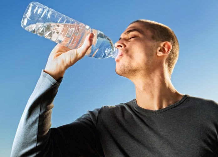 Man drinking from a water bottle