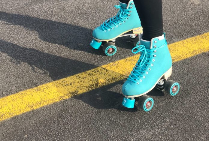 Woman in a pair of blue roller skates