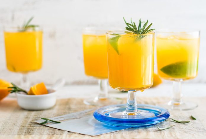 Glasses of orange juice with lime
