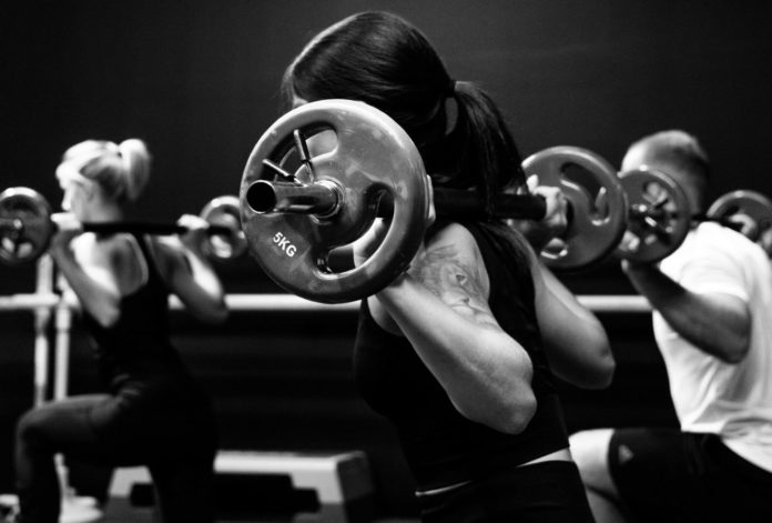 Woman lifting weights at the gym