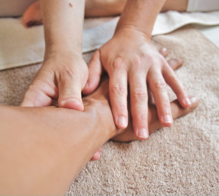 Person giving hand massage