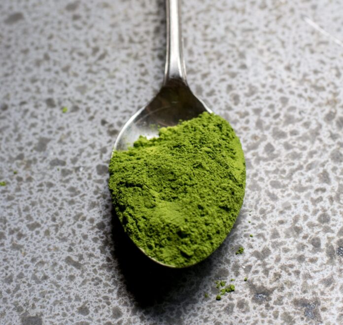 Green powder on a spoon