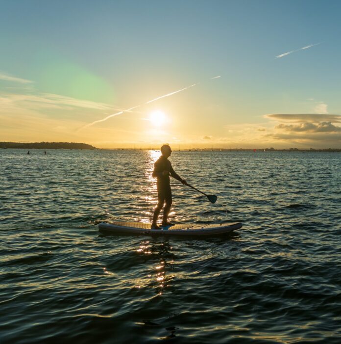 Man paddleboarding in the ocean